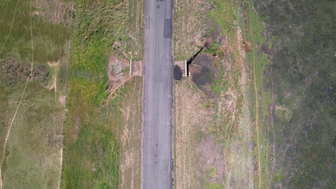 Top down aerial view tracking along empty road through lush natural landscape, Apure, Venezuela