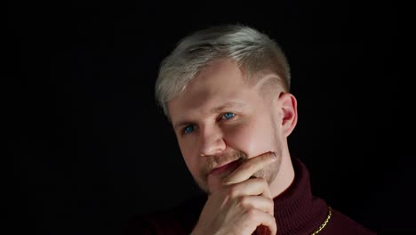 Thinking-man-looking-up-and-around-contemplating-how-to-solve-problem-against-black-background