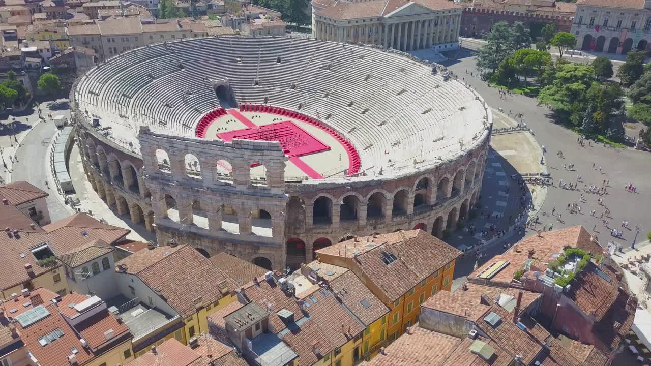 Aerial panoramic view of Arena di Verona, Italy. The drone flies from houses with scooped roofs to the Arena. A view of the Arena and the city opens. 4k vieo.