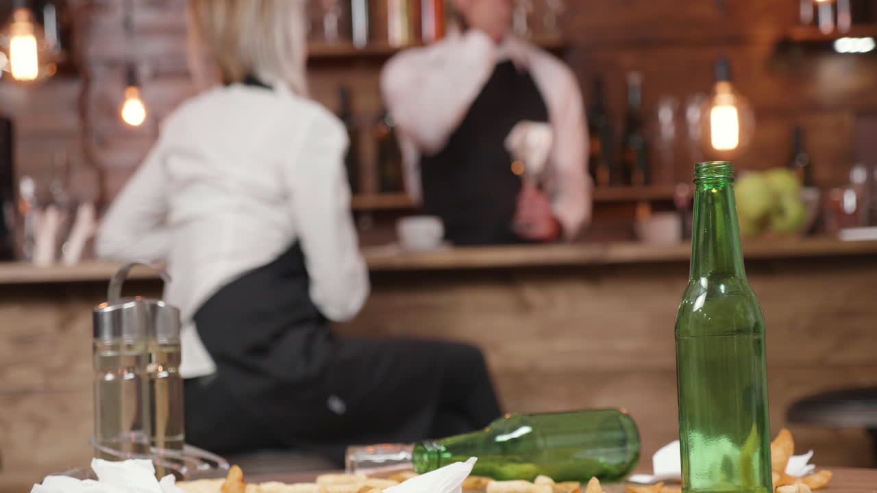 Scene in a bar with used beer bottles