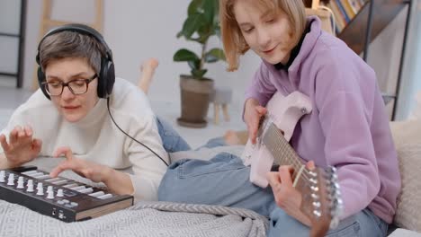 Mother and daughter learning music together at home