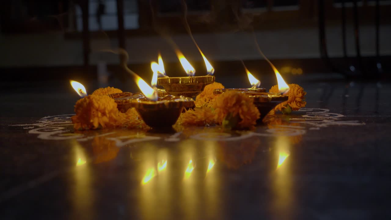 Diya lamps lit during Diwali celebration of Indian Hindu Light Festival called Diwali, rengoli decoration during deepavali
