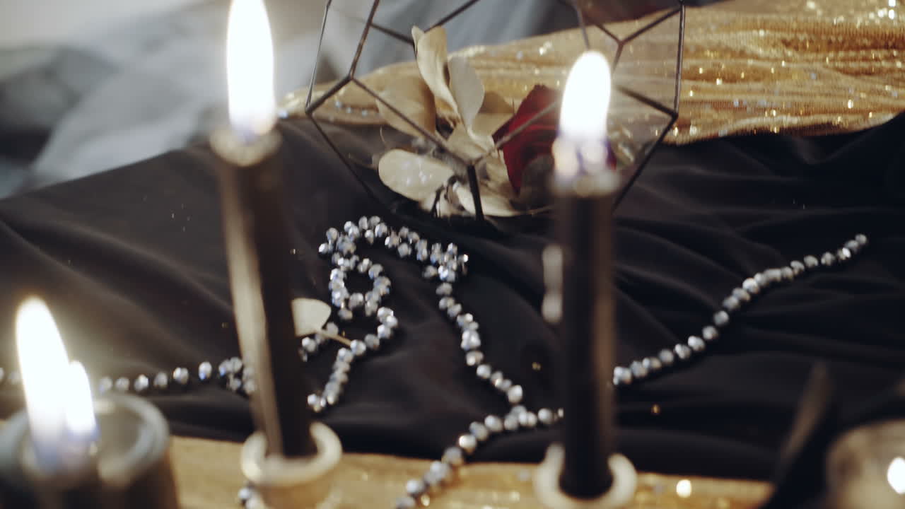 Witch sitting by the table. Portrait of young witch woman sitting at table in room