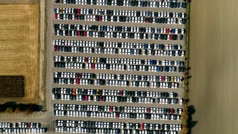 Aerial-footage-of-finished-cars-ready-to-be-shipped-on-huge-distribution-center