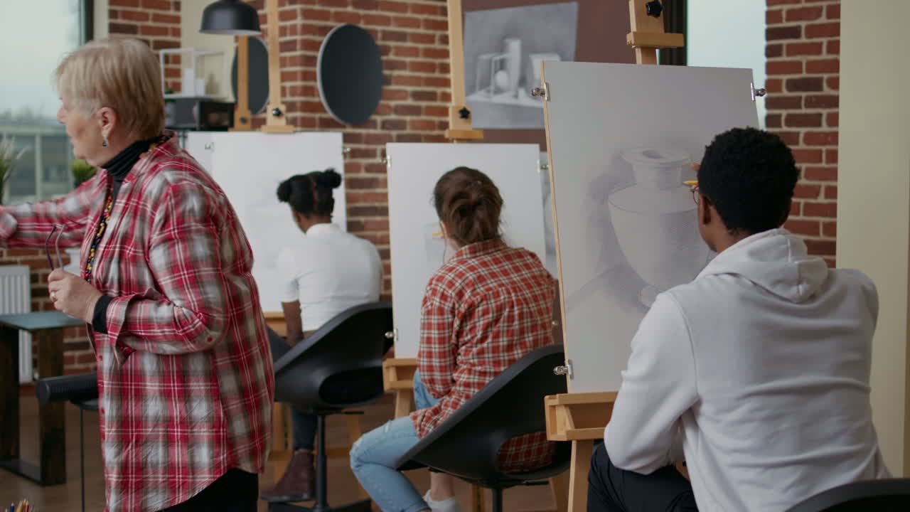 Diverse group of students attending art class lesson in studio