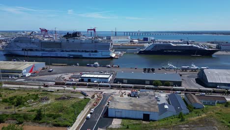 The industrial port of Saint-Nazaire with two magnificent boats, France. Aerial drone sideways