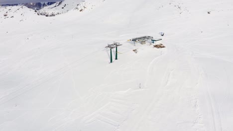 Aerial-birds-eye-shot-of-ski-lift-on-top-of-italian-mountain-during-covid19-shutdown