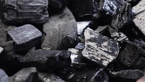 flammable liquid splashes across coals preparing them for outdoor grilling