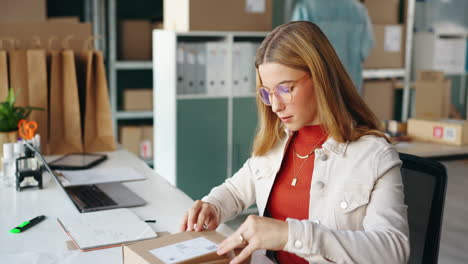woman packing boxes in her office