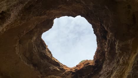 Hole-in-the-middle-of-the-rooftop-rocks-at-Portugal,-Algar-de-Benagil