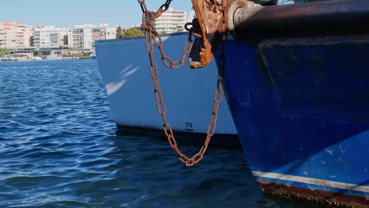 Chain hanging from a docked fishing boat in Santa Pola, Spain