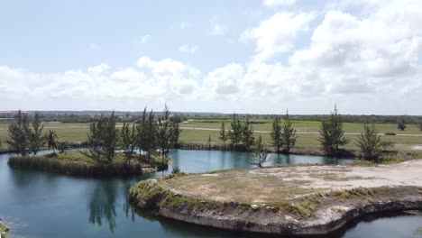 aerial-shot-of-drone-crossing-between-two-residential-buildings-in-punta-cana,-caribbean-lifestyle,-beautiful-tropical-ambiance