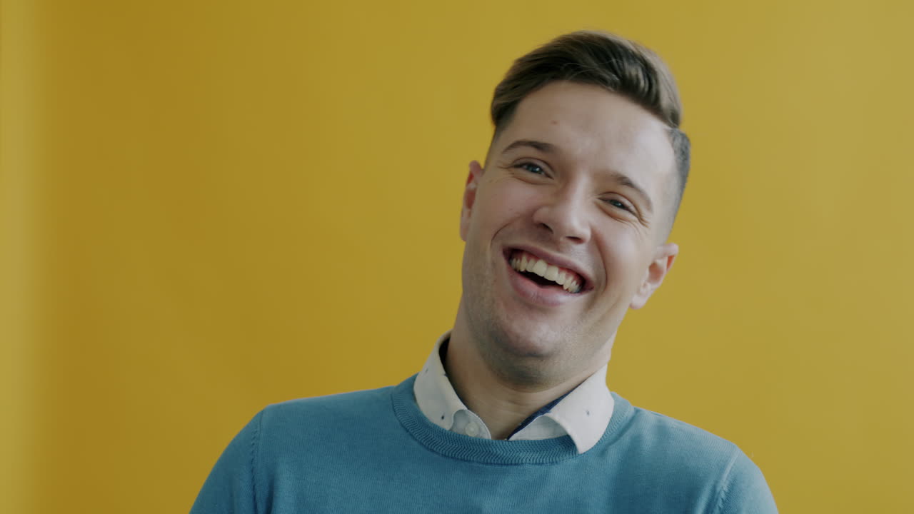 Smiling Man in Front of a Yellow Background