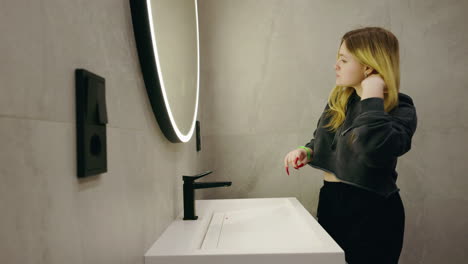 teenager getting ready in a modern bathroom