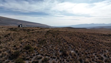 Drone-flying-closely-over-dry-grassy-land-beside