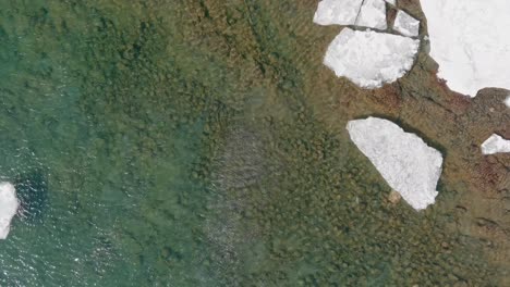 ice floating in clear calm waters of lake superior in minnesota - medium shot