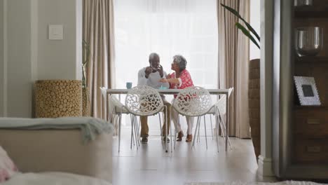 a senior african american couple spending time together at home in social distancing