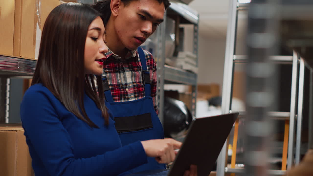 Warehouse workers checking inventory on a tablet
