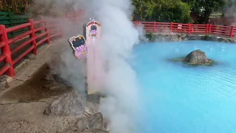 umi jigoku or sea hell taken in beppu with steamy hot springs geyser steaming off the cobalt water