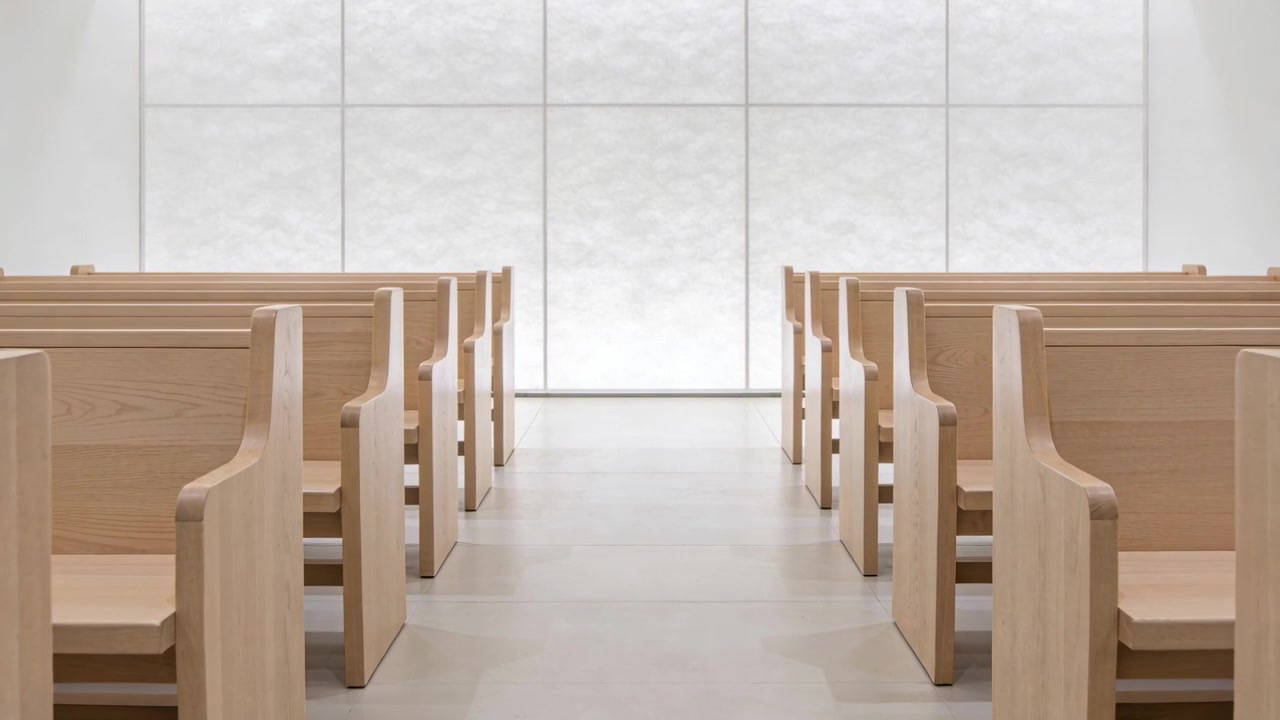 Gliding camera dollying forward in chapel focusing on frosted glass wall showing light wood pews