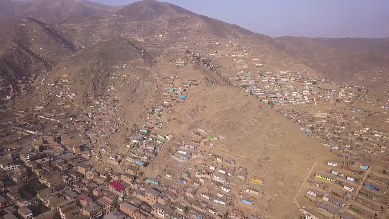 Scattered hillside homes in a dry, rugged landscape. A powerful visual for urban expansion, poverty studies, and environmental impact projects