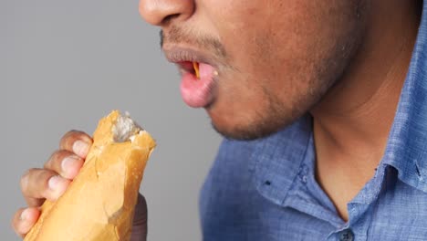 man eating baguette