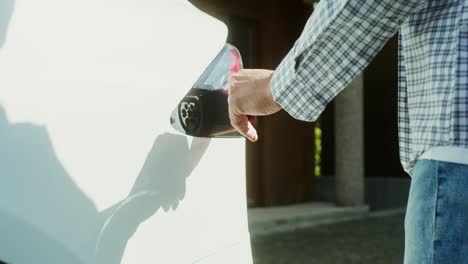 person charging an electric car