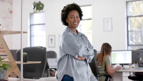 Portrait-of-happy-african-american-casual-businesswoman-in-office,-slow-motion