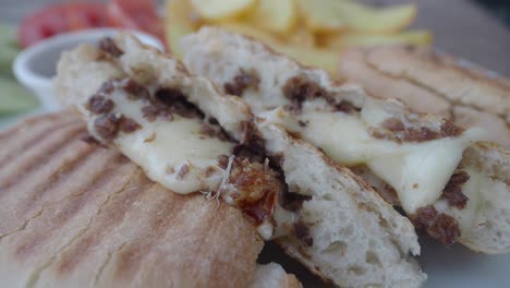 sandwich with melted cheese and french fries