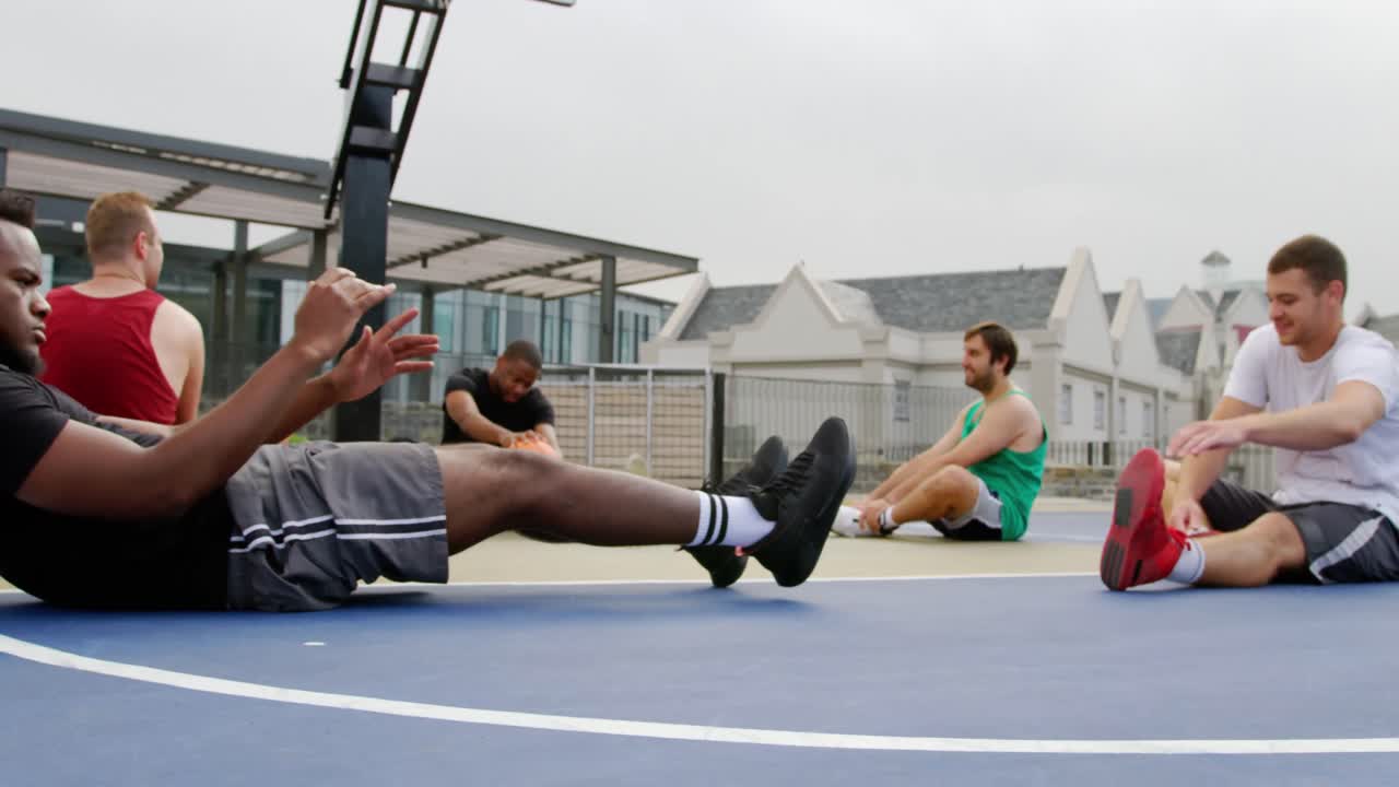 Basketball players exercising in basketball court 4k