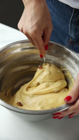 mixing dough with raisins