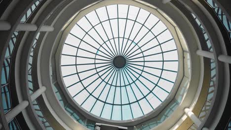 the camera shoots a beautiful stained glass window from below with rotation. round glass roof