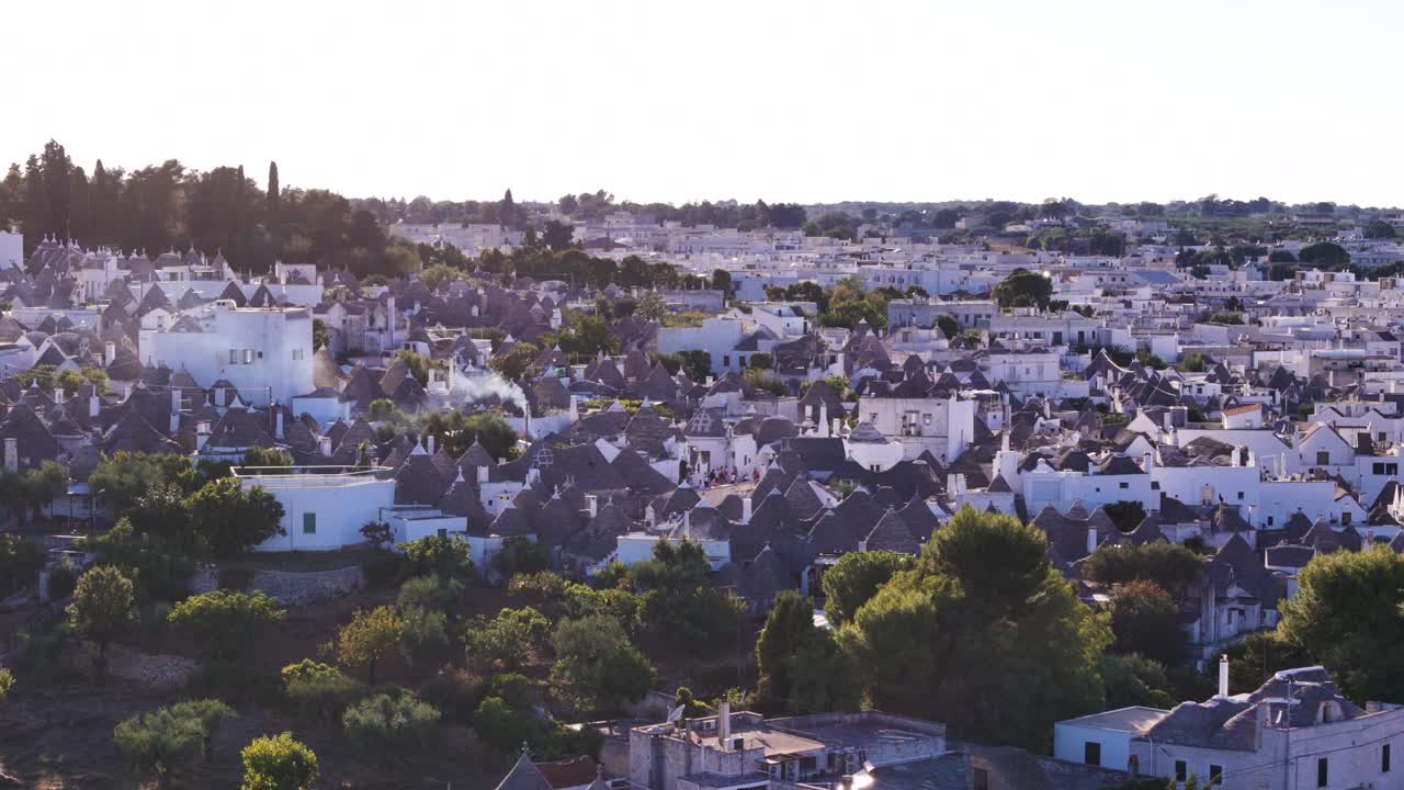 Edifici patrimonio dell'UNESCO di Alberobello con fumo di camino, vista aerea