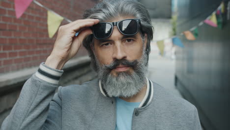 older man with sunglasses in urban setting