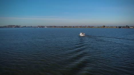 -drone-view-of-a-ship-riding-on-the-sea-under-the-blue-sky