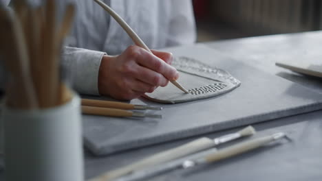 woman creating pottery piece