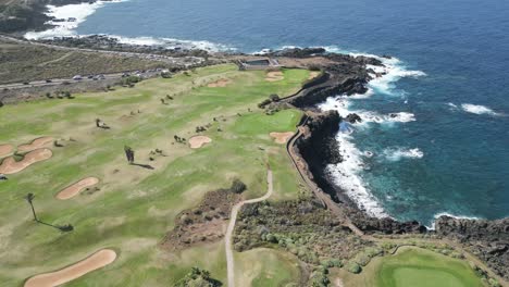 High-angle-establish-of-perfect-golf-course-on-rocky-sea-cliffs-overlooking-the-ocean