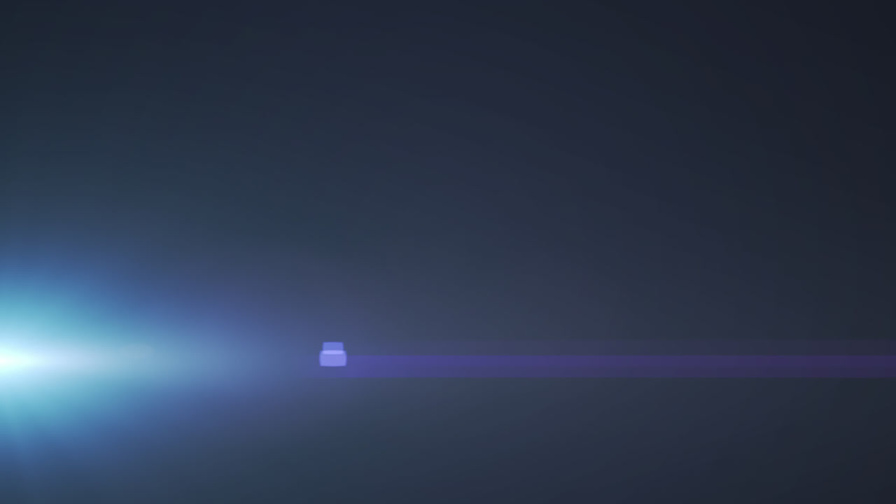 Glowing blue spot of light flickering against black background