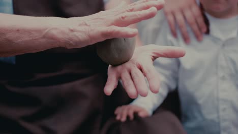 close up hands make pitchers in pottery