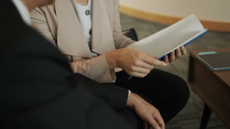 health insurance broker explaining plan to chinese client in office