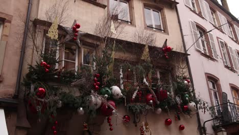 christmas bells and tinsel decorating storefronts on european street at a festive christmas market in europe