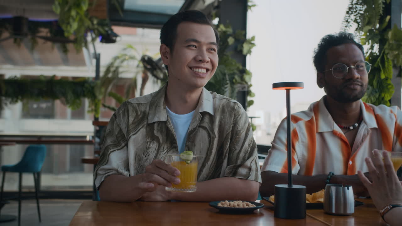 Diverse Men Chatting with Friend while Drinking in Cafe