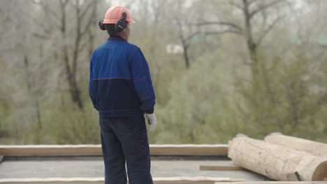 construction worker on a log home building site