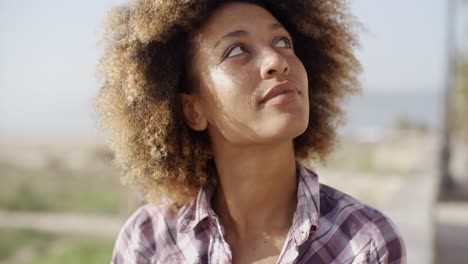 woman with happy expression relaxing on nature