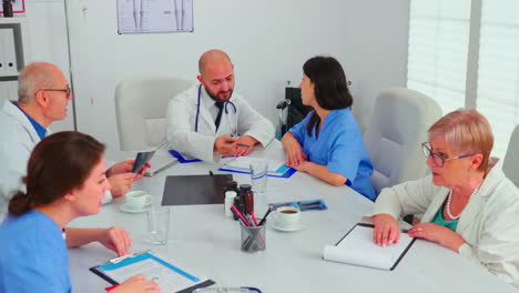 medical expert talking with medical staff during healthcare meeting