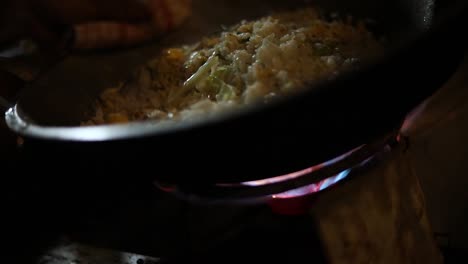 Shot-of-a-street-vendor-cooking-their-indonesian-food-to-sell-in-a-pot-over-a-flame