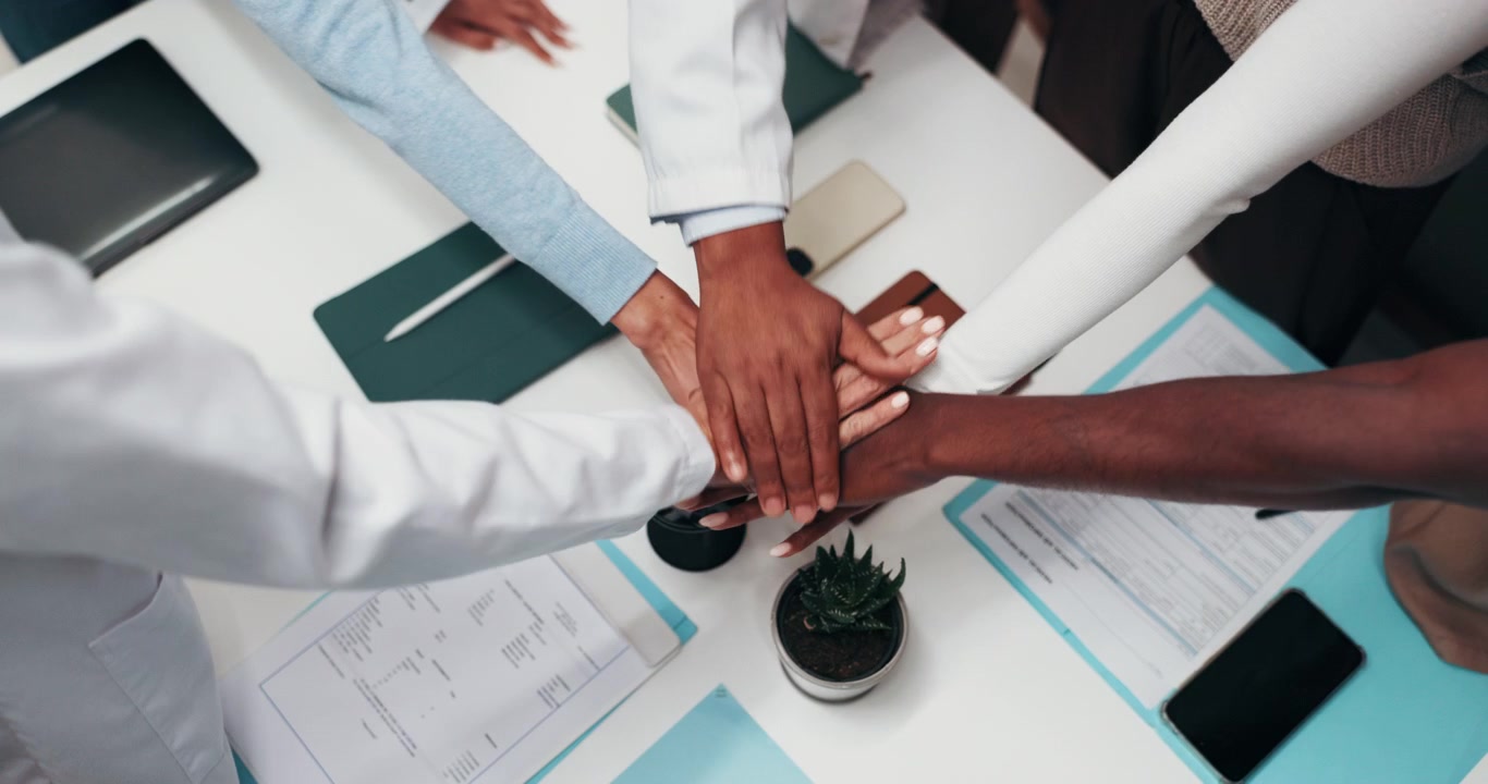 Diverse Business Team Stacking Hands in Office Meeting