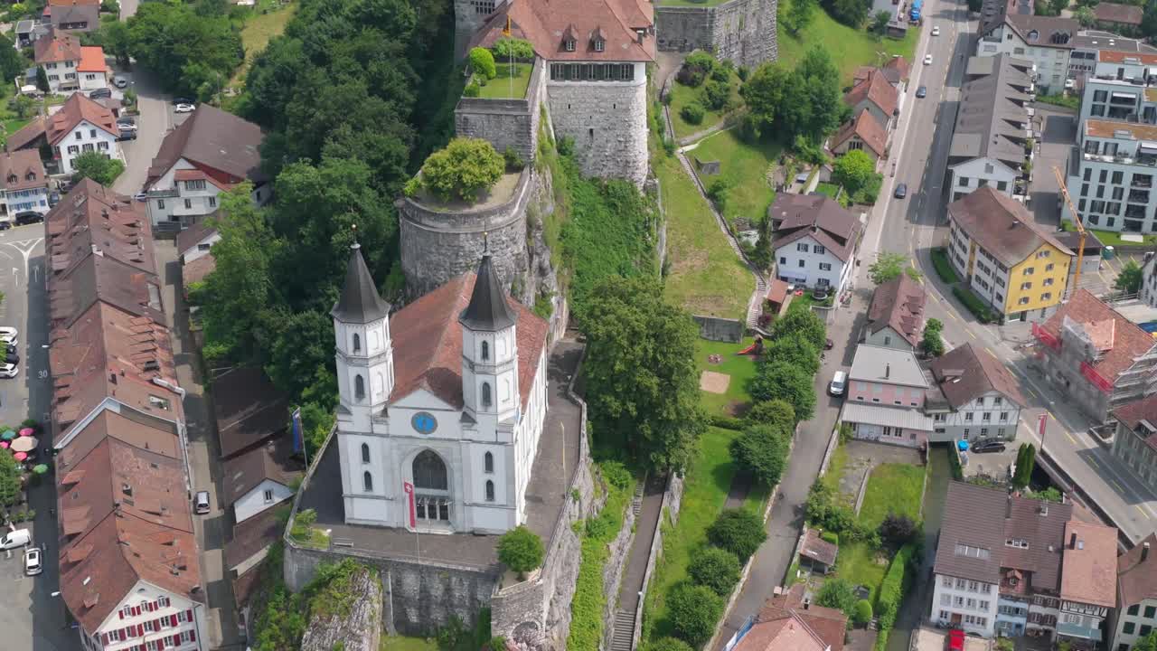 Sweeping aerial showing fortress from above with rooftops fanning out below