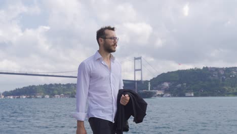 Thoughtful-man-walking-by-the-sea.