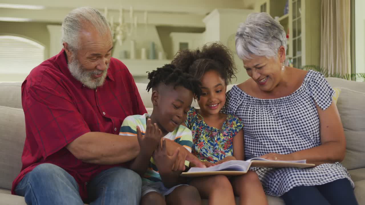 Grandparents and grandchildren reading book at home